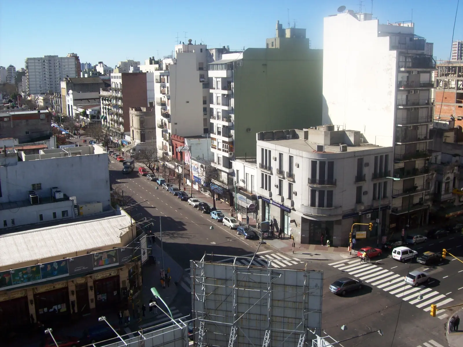 Avenida Boedo running away from the corner of Avenida San Juan in the Boedo barrio, seen from a high window, with apartment blocks on both sides